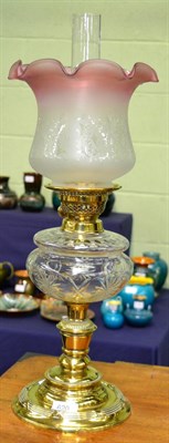 Lot 620 - A Victorian brass oil lamp with clear glass reservoir