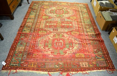 Lot 1134 - A 19th century Kazak rug, Central Caucasus, the scarlet field with three hooked octagons...