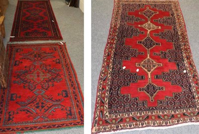 Lot 1137 - A Kurdish rug, the blood red stepped field with five linked medallions framed by narrow...