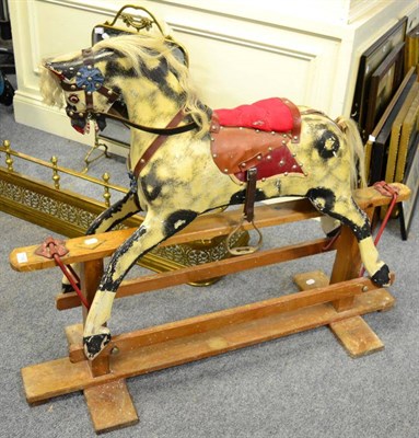 Lot 1186 - A painted rocking horse on trestle base