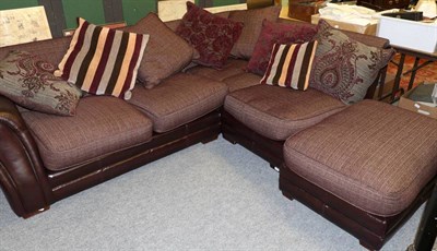 Lot 1188 - A leather and red fabric four-seater corner sofa, with scatter cushions, maximum width 260cm; and a