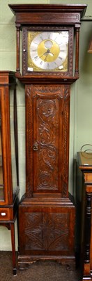 Lot 1216 - An oak carved thirty hour longcase clock, brass dial with silvered recessed plaque inscribed...