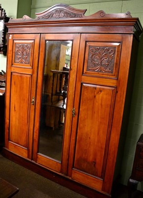 Lot 1221 - An early 20th century mirror fronted triple wardrobe