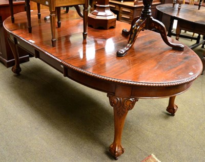 Lot 1239 - A Georgian style mahogany extending dining table, gadrooned rim, ball and claw feet, with two...