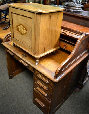 Lot 1248 - An early 20th century oak roll top desk and a music cabinet