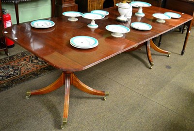 Lot 1256 - A mahogany twin pillar dining table with two additional leaves