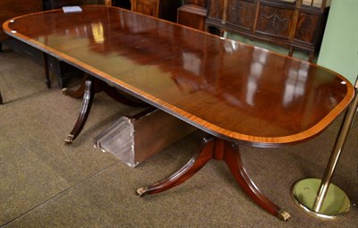 Lot 1258 - A reproduction mahogany, satinwood banded and boxwood strung twin-pedestal dining table in...