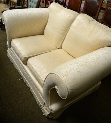 Lot 1263 - A cream two seater sofa