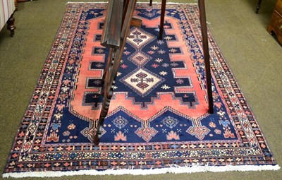 Lot 1276 - An Afshar rug, the shaped indigo field with three hooked medallions enclosed by triple narrow...