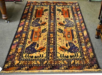 Lot 1279 - ;Mushwani; Balouch rug, Afghanistan, the charcoal field with three hooked medallions enclosed...