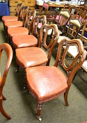 Lot 1290 - A set of six Victorian mahogany balloon-back dining chairs with leather seats, and fluted legs...