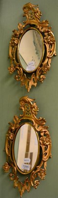 Lot 1299 - Pair of gilt metal wall mirrors