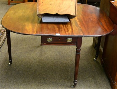 Lot 1310 - A late George III mahogany Pembroke table on reeded legs