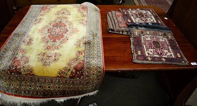 Lot 1321 - Two Kilim flat weave saddle bags, geometric decoration and a Persian silk rug (3)