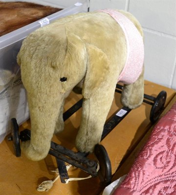 Lot 1407 - Circa 1940s Merrythought Pull Along Elephant, with yellow plush, on a metal frame bearing the...