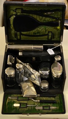 Lot 1424 - Finnigans of London black leather dressing case, with green silk lining, glass fittings with plated