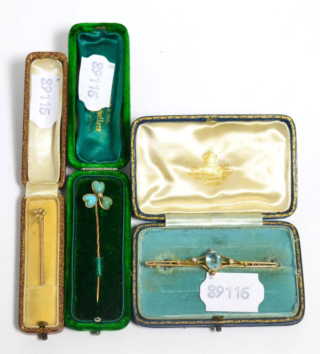 Lot 7 - A 9 carat gold and gem set bar brooch and two gold scarf pins, all cased