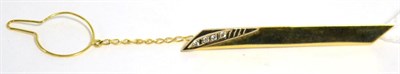 Lot 9 - A yellow metal tie clip, stamped 18 carat, inset with four stones