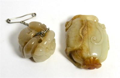 Lot 22 - A carved jade netsuke decorated with birds and a carved jade pebble in the form of a seed (2)