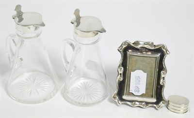 Lot 32 - A near pair of silver mounted whisky noggins by Mappin & Webb, a miniature silver photograph...