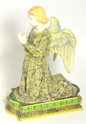 Lot 107 - An Italian tin glazed earthenware figure of a kneeling angel in the Pre-Raphaelite taste