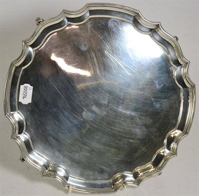 Lot 146 - A plain shaped circular silver salver, A Chick & Sons, London 1972, on scroll supports, 30cm...