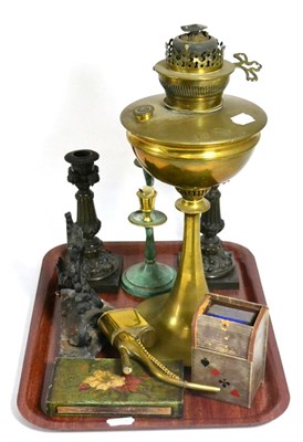 Lot 173 - A tray including brass oil lamp, candlesticks, door stops, oil can etc