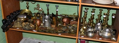 Lot 179 - Two shelves of brass ware, candlesticks, copper, tankards, treen, horse brasses etc