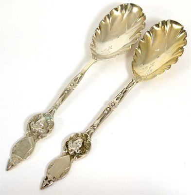 Lot 221 - A pair of Victorian silver serving spoons, Charles Edwards, London 1876 and 1878, the handles...