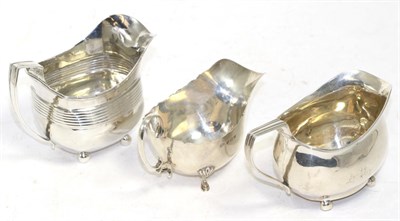 Lot 242 - Two George III silver cream jugs, London 1806 and 1814; and a silver sauce boat, Birmingham...