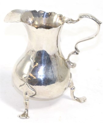 Lot 254 - A George III silver cyma-edge cream jug