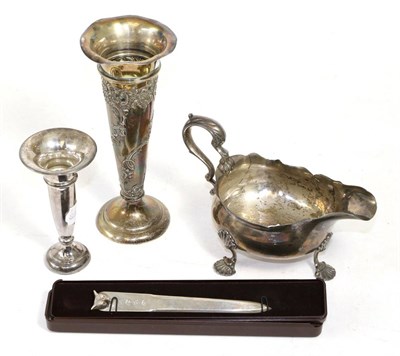 Lot 270 - A George III silver sauceboat, marks rubbed; a late Victorian silver posy vase; a later smaller...