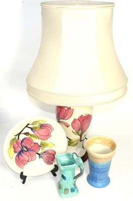 Lot 300 - A Moorcroft magnolia pattern lamp with shade and a plate; together with a Wadeheath vase and...