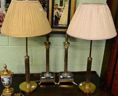 Lot 326 - A pair of gilt metal Corinthian columnar table lamps on square stepped variegated green marble...