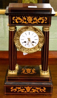 Lot 329 - A rosewood inlaid portico striking mantel clock