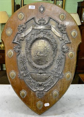 Lot 342 - A mid 20th century large oak shield shape trophy plaque with plated mounts, ";The Massey...