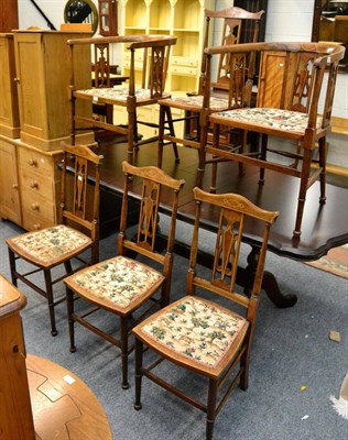 Lot 1142 - A set of six chairs including four dining chairs with yoke crest rails and a pair of barrel...