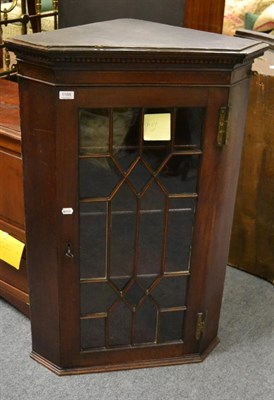 Lot 1166 - A mahogany and astragal glazed hanging corner cupboard