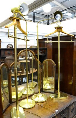 Lot 1178 - Two adjustable brass freestanding lamps with a pair of brass and wood freestanding jacket...