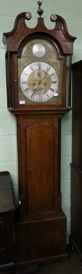 Lot 1231 - An oak eight day longcase clock, with arched brass dial with silvered plaque bearing a later...