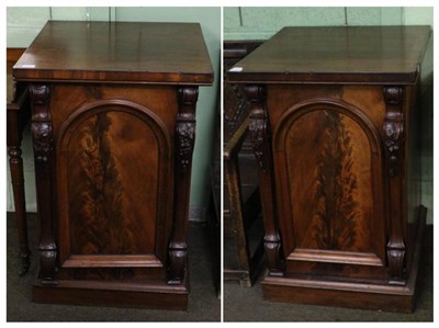 Lot 1239 - A pair of mahogany pedestals with arched panel doors, one fitted with slides, one fitted with a...