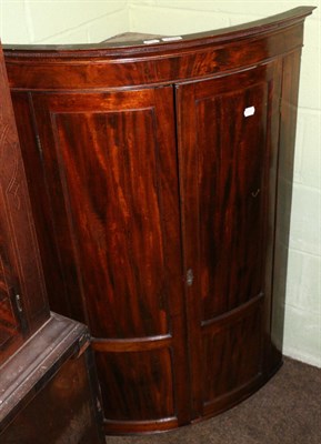 Lot 1250 - A 19th century mahogany hanging bow fronted corner cupboard