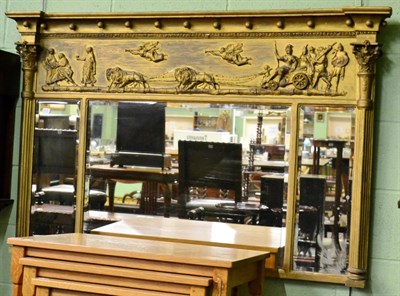 Lot 1252 - A Regency inverted breakfront gilt framed sectional mirror, the three bevelled plates flanked...