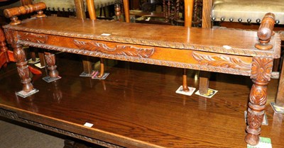 Lot 1268 - A carved oak window seat