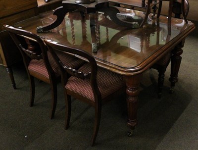 Lot 1279 - A mahogany table with one leaf, winder and glass top and a set of four mahogany balloon back chairs