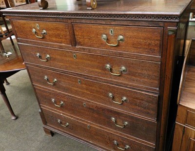 Lot 1283 - An impressive George III oak five height chest of drawers, the dentil cornice above two short...