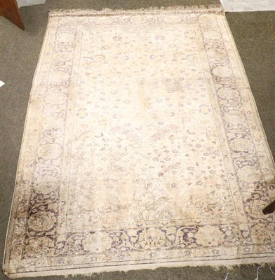 Lot 1289 - A Bandirma rug, the ivory field with birds, flowers and animals enclosed by meandering vine...