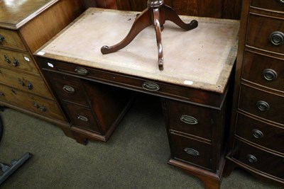 Lot 1294 - An early 20th century mahogany leather inset pedestal desk of small proportions