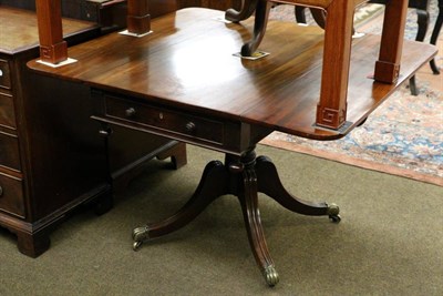 Lot 1303 - A late George III mahogany pedestal drop leaf table