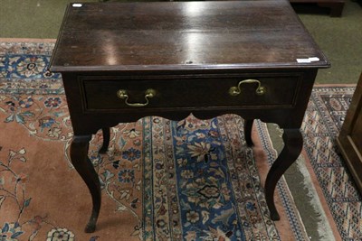 Lot 1304 - An oak lowboy with frieze drawer raised on cabriole legs, 18th century and later, 83cm wide